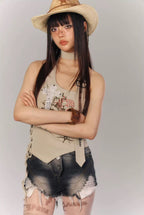 Woman wearing a hat and casual outfit with a plain background